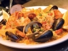 black whale seafood paella mussels shrimp littlenecks squid in spicy saffron rice with chorizo and peas.jpg